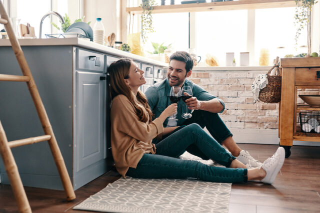 couple drinking wine in kitchen