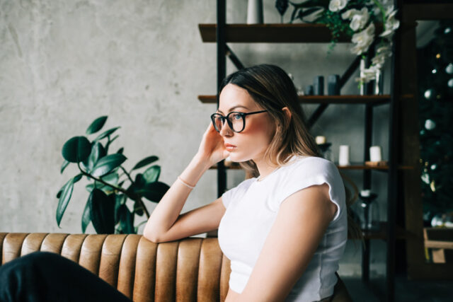 bored woman sitting on couch