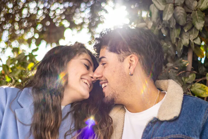 young couple kissing in sunlight